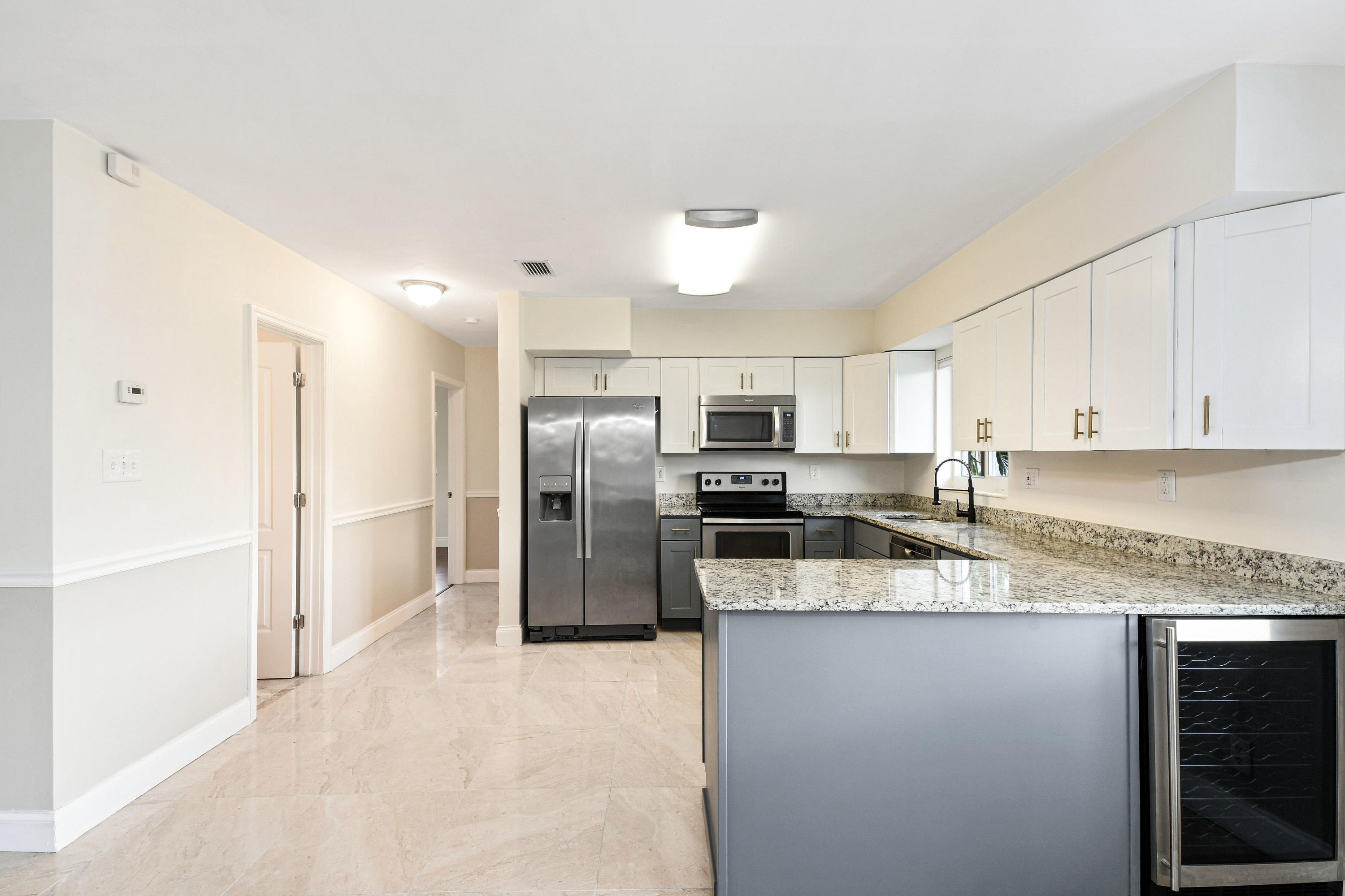 2003 Park Place Boca Raton, FL 33486 - Photo 12 of 42 a kitchen with stainless steel appliances granite countertop a refrigerator a stove a sink and a microwave