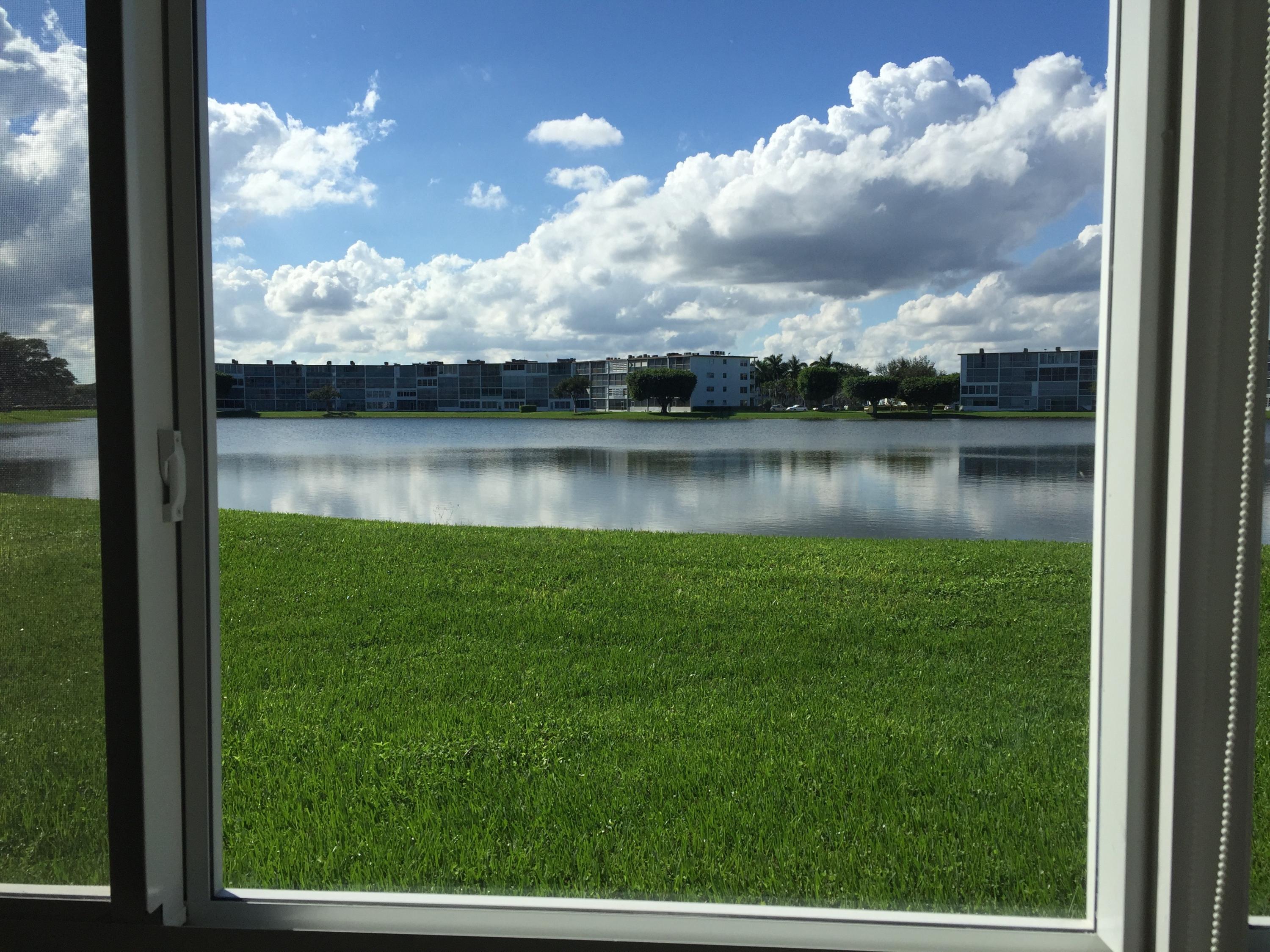 1072 Exeter Boca Raton, FL 33434 - Photo 32 of 32 PATIO VIEW THROUGH HIGH IMPACT GLASS