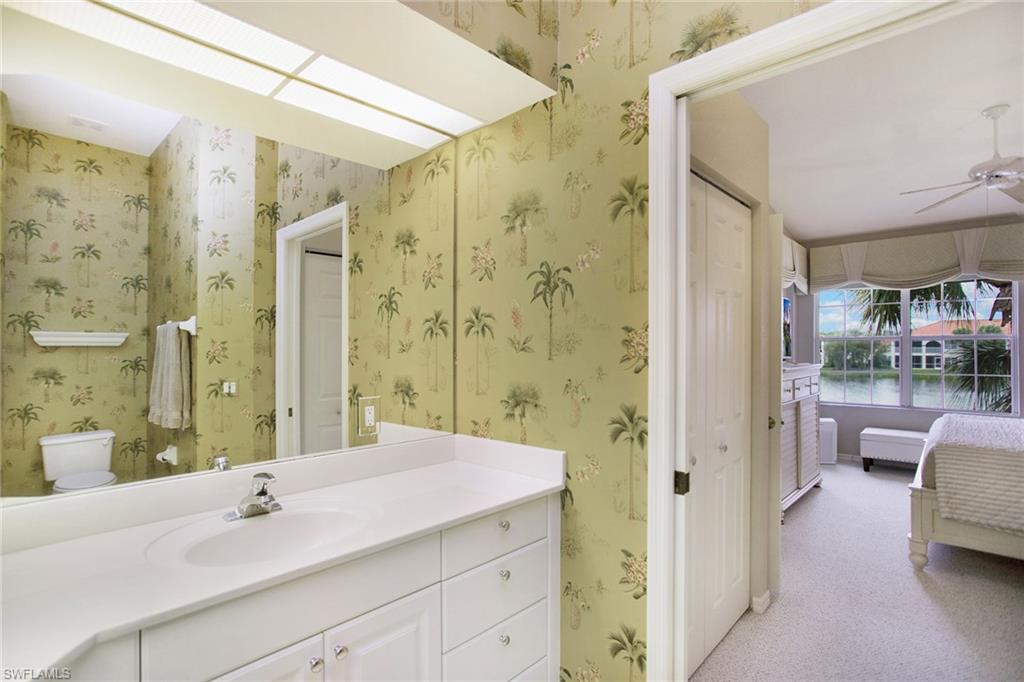 23821 Marbella Bay Road, Unit 202 Estero, FL 34135 - Photo 12 of 42 a bathroom with a sink a shower and a mirror