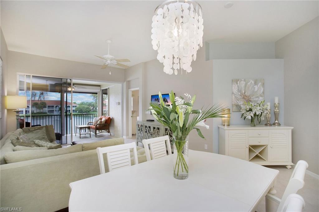 23821 Marbella Bay Road, Unit 202 Estero, FL 34135 - Photo 17 of 42 a view of a dining room with furniture a chandelier and large window