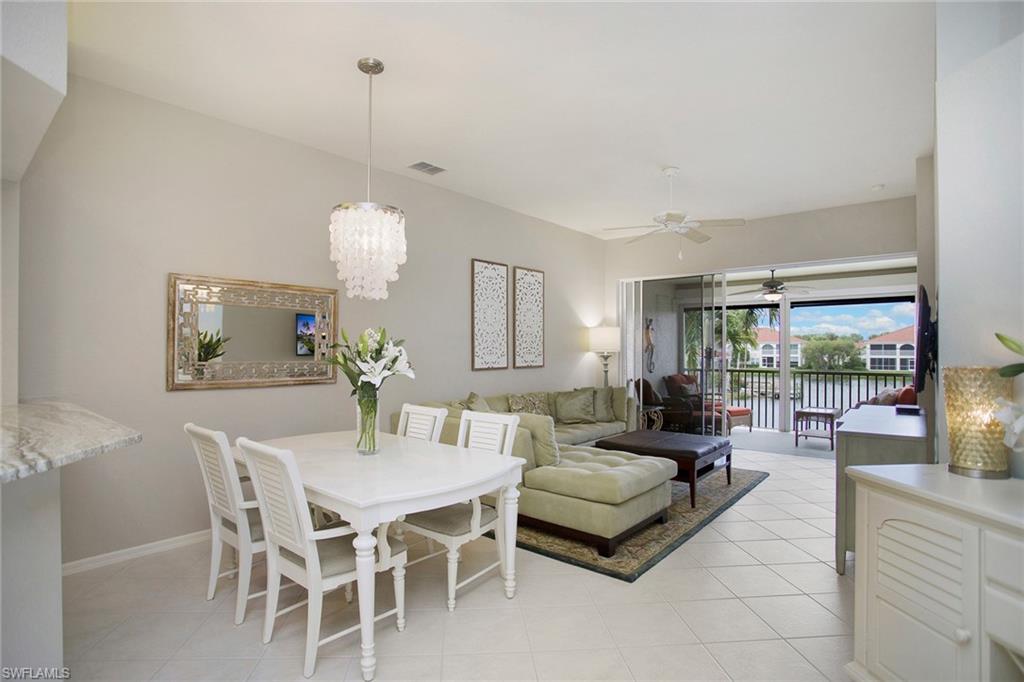 23821 Marbella Bay Road, Unit 202 Estero, FL 34135 - Photo 18 of 42 a living room with furniture a lamp and a chandelier