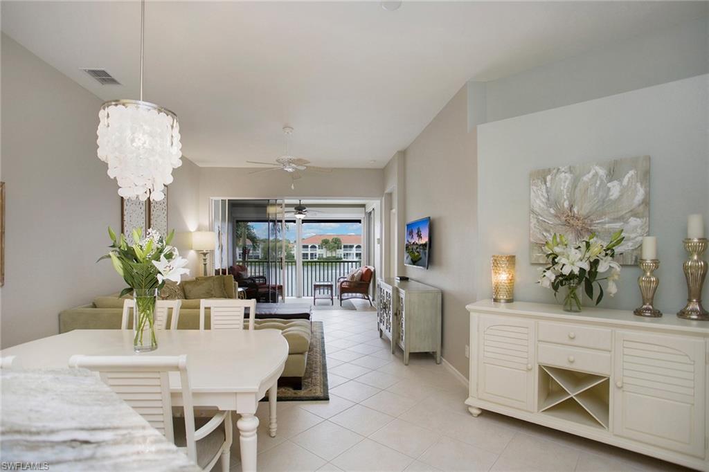 23821 Marbella Bay Road, Unit 202 Estero, FL 34135 - Photo 19 of 42 a living room with fireplace furniture and a chandelier