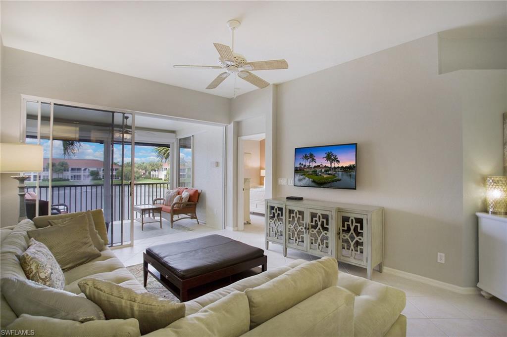 23821 Marbella Bay Road, Unit 202 Estero, FL 34135 - Photo 2 of 42 a living room with furniture and a flat screen tv