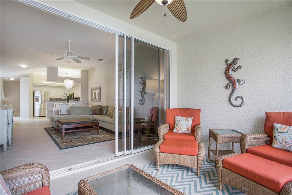23821 Marbella Bay Road, Unit 202 Estero, FL 34135 - Photo 23 of 42 a room with furniture and a table