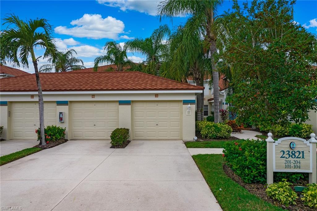 23821 Marbella Bay Road, Unit 202 Estero, FL 34135 - Photo 27 of 42 a view of a house with a yard and garage
