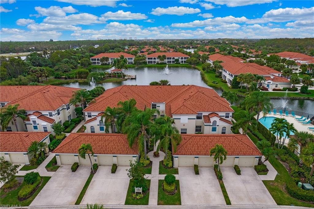 23821 Marbella Bay Road, Unit 202 Estero, FL 34135 - Photo 28 of 42 an aerial view of house with yard and lake view
