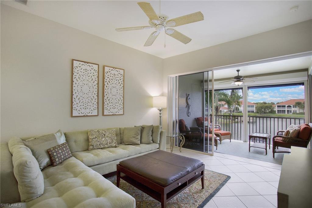 23821 Marbella Bay Road, Unit 202 Estero, FL 34135 - Photo 3 of 42 a living room with furniture and a large window