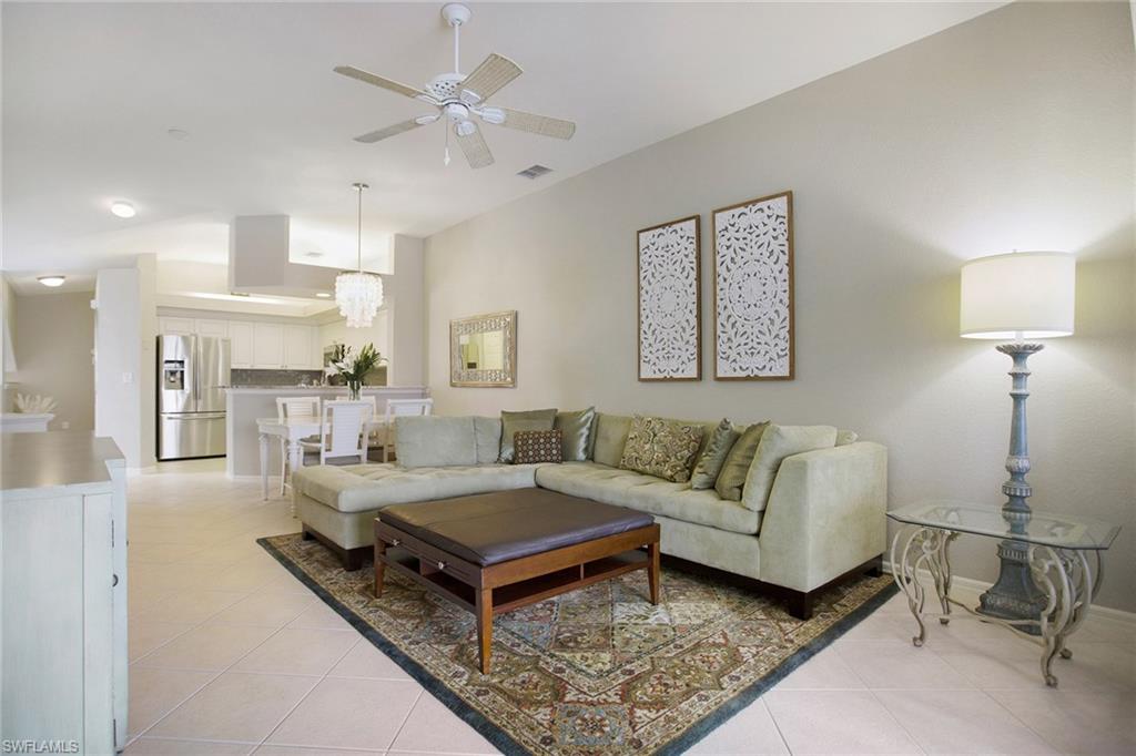 23821 Marbella Bay Road, Unit 202 Estero, FL 34135 - Photo 4 of 42 a living room with furniture and a table