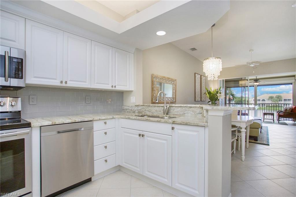 23821 Marbella Bay Road, Unit 202 Estero, FL 34135 - Photo 6 of 42 a kitchen with white cabinets and sink