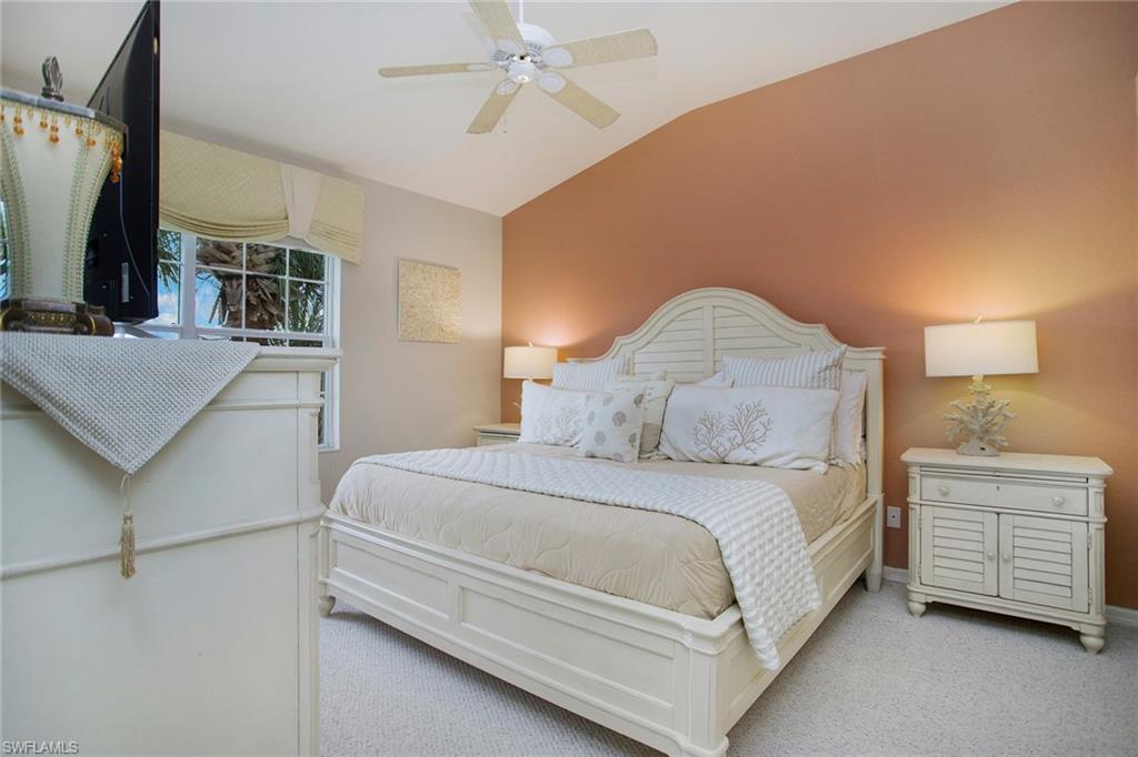23821 Marbella Bay Road, Unit 202 Estero, FL 34135 - Photo 8 of 42 a bedroom with a bed and a flat tv screen on dresser