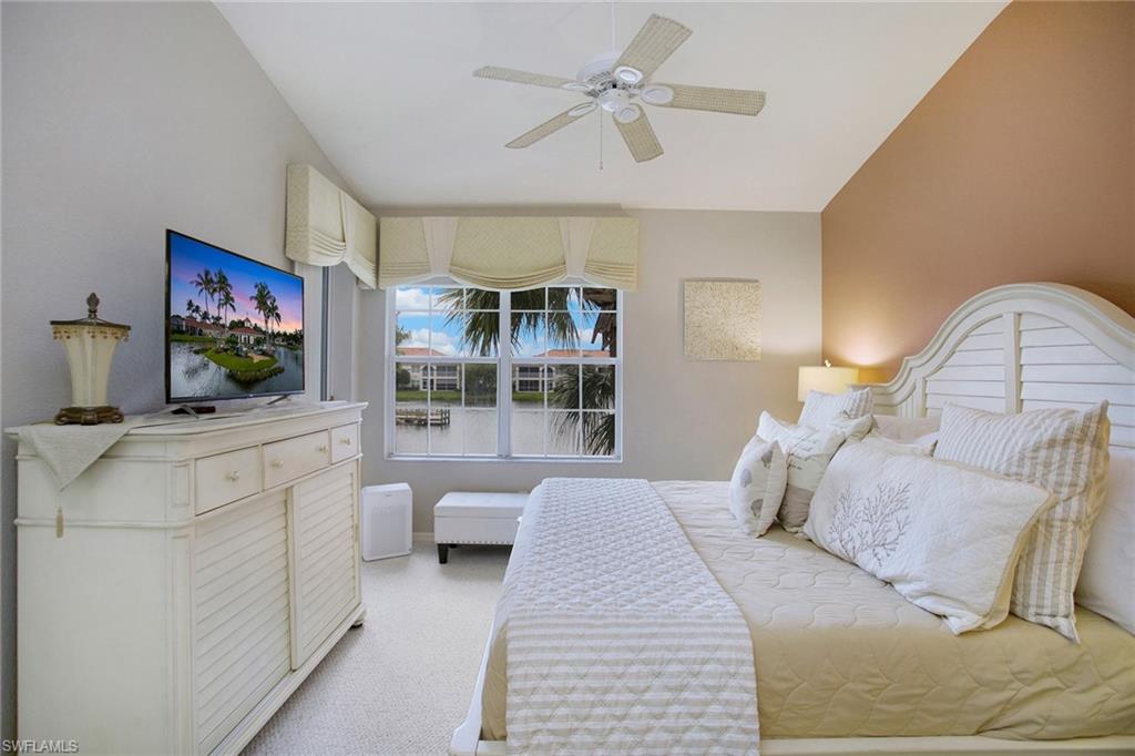 23821 Marbella Bay Road, Unit 202 Estero, FL 34135 - Photo 9 of 42 a bedroom with a large bed and a flat screen tv