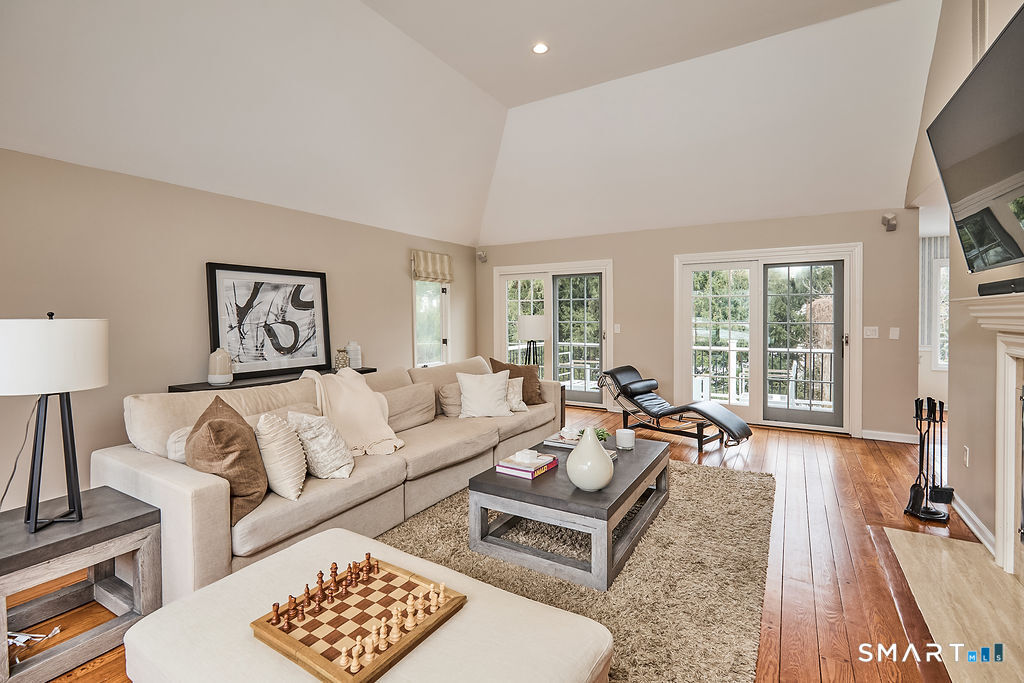 23 Harborview Road Westport, CT 06880 - Photo 11 of 35 a living room with furniture floor to ceiling window and a flat screen tv