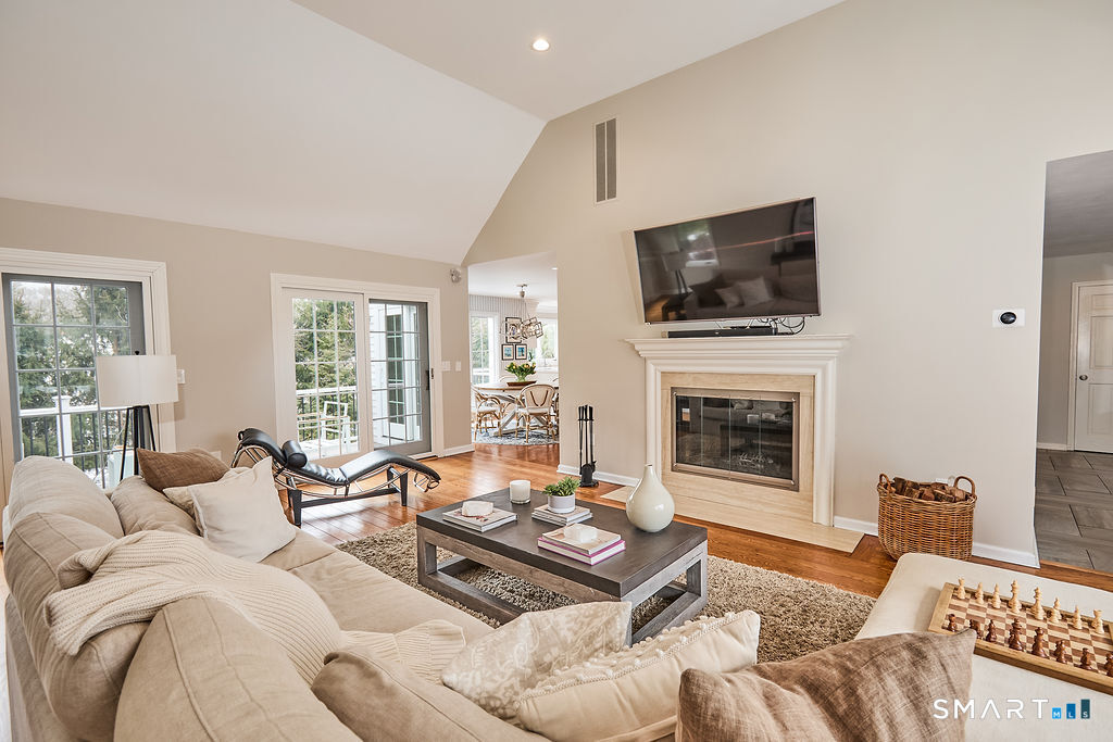 23 Harborview Road Westport, CT 06880 - Photo 13 of 35 a living room with furniture a flat screen tv and a fireplace