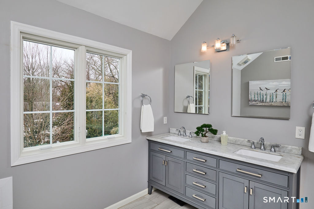 23 Harborview Road Westport, CT 06880 - Photo 21 of 35 a bathroom with a sink double vanity and a window