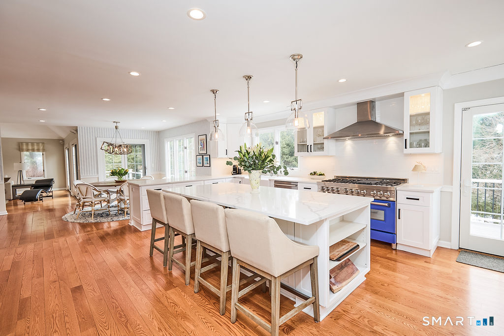 23 Harborview Road Westport, CT 06880 - Photo 3 of 35 a kitchen with stainless steel appliances kitchen island granite countertop a stove a sink and a refrigerator