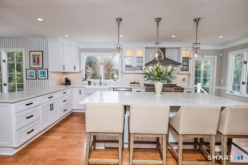 23 Harborview Road Westport, CT 06880 - Photo 4 of 35 a kitchen with stainless steel appliances kitchen island granite countertop a table chairs and a refrigerator