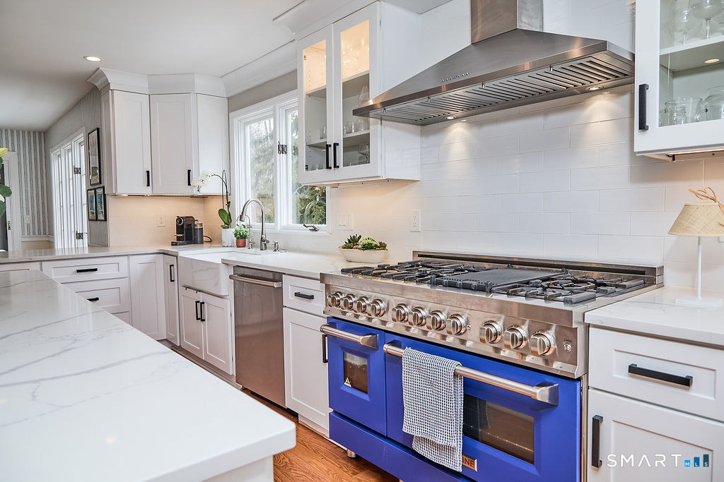 23 Harborview Road Westport, CT 06880 - Photo 5 of 35 a kitchen with stainless steel appliances a stove and white cabinets