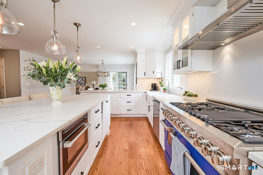 23 Harborview Road Westport, CT 06880 - Photo 6 of 35 a kitchen with stainless steel appliances a sink a stove top oven a counter space and cabinets