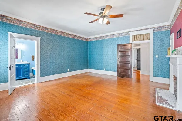 a view of empty room with wooden floor