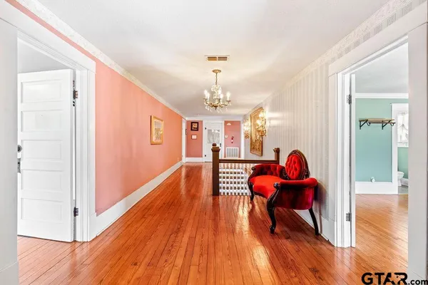 a living room with dining room and wooden floor