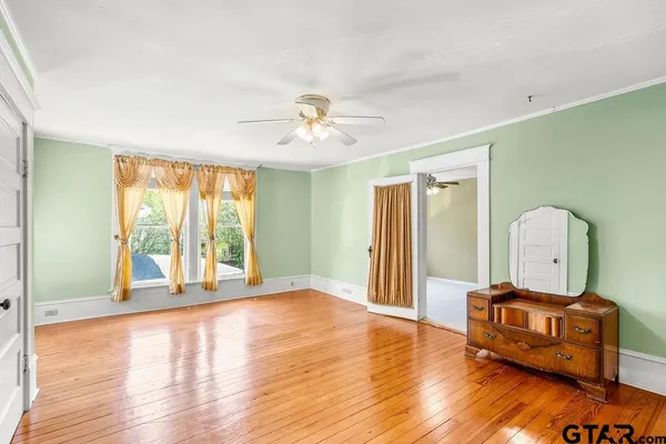 a view of a room with window and chandelier fan