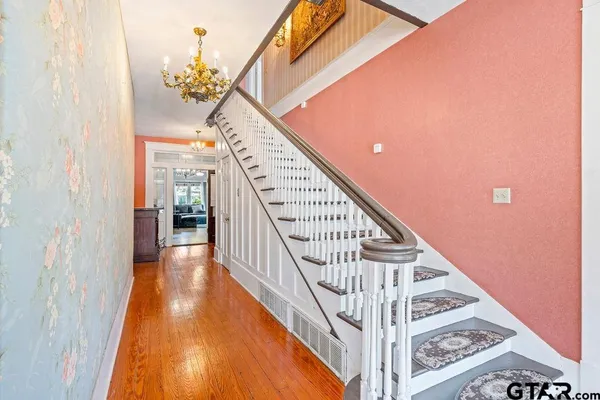 a view of entryway and hall with wooden floor