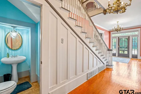 a view of entryway and hall with wooden floor