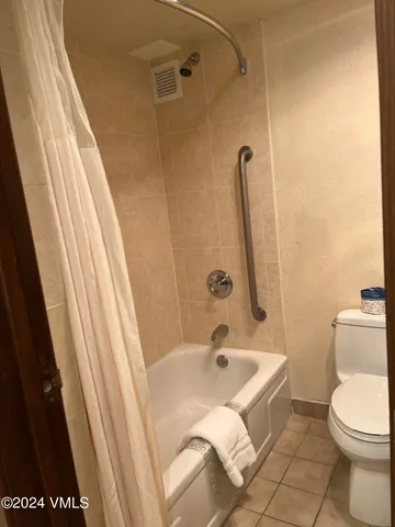 a bathroom with a sink a toilet a shower and a tub