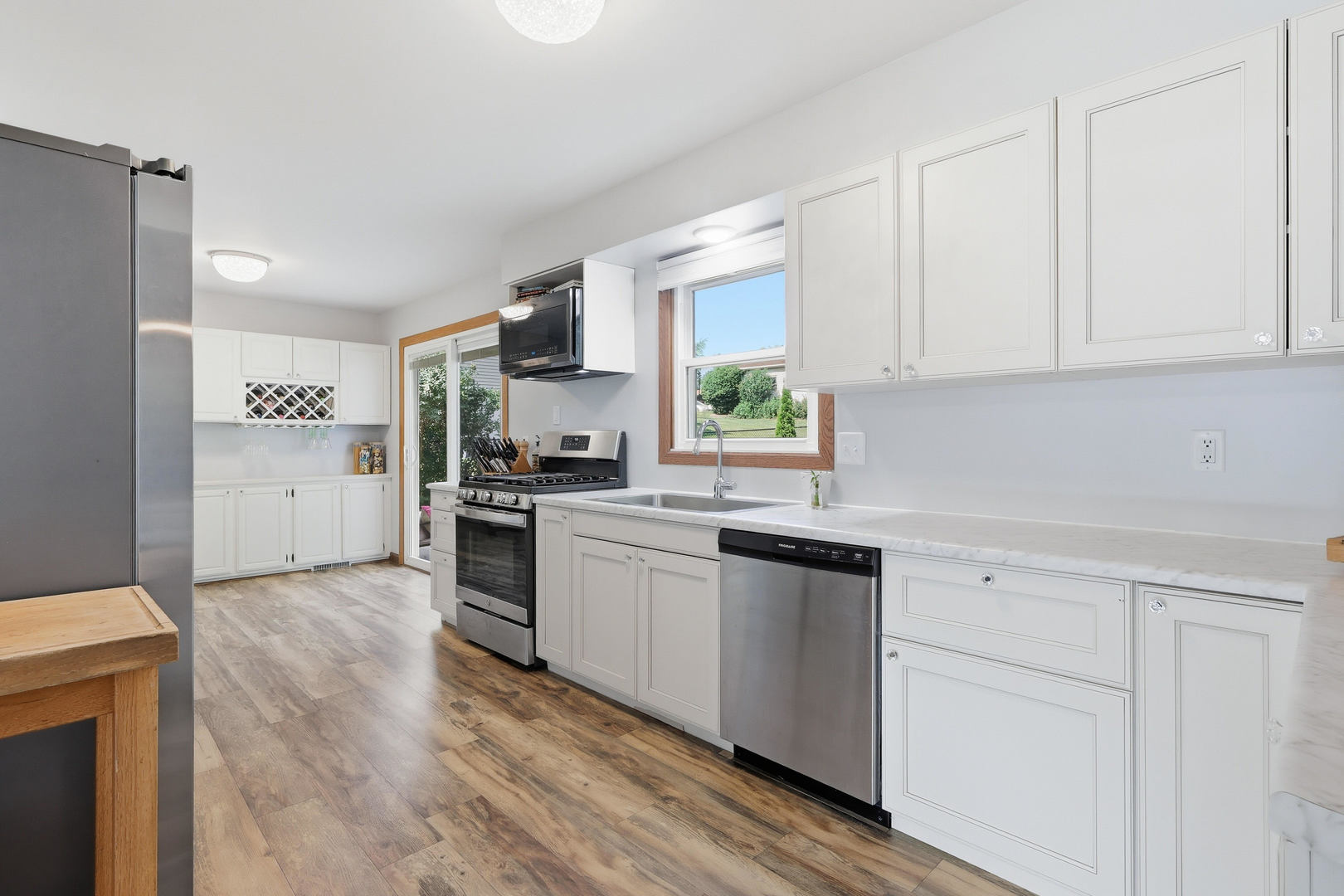 4314 Spring Street Davenport, IA 52807 - Photo 13 of 51 a kitchen with granite countertop white cabinets and white appliances