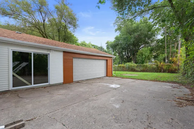 a view of a house with a yard and garage