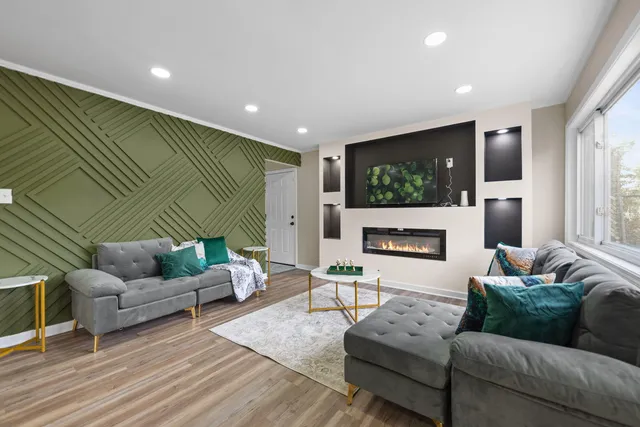 a living room with furniture flat screen tv and a fireplace