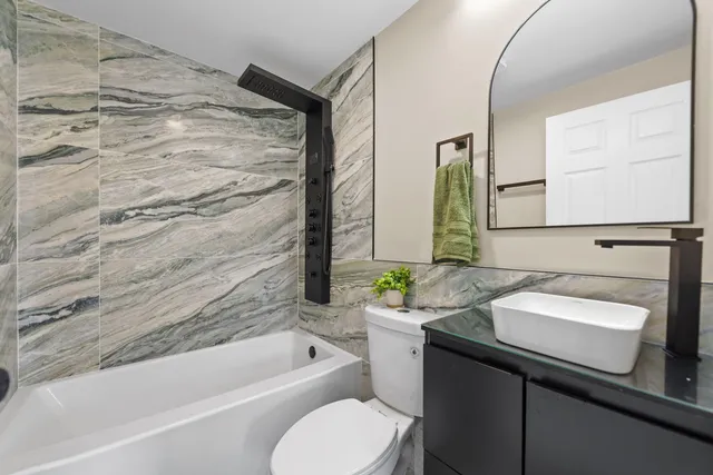 a bathroom with a sink toilet and tub