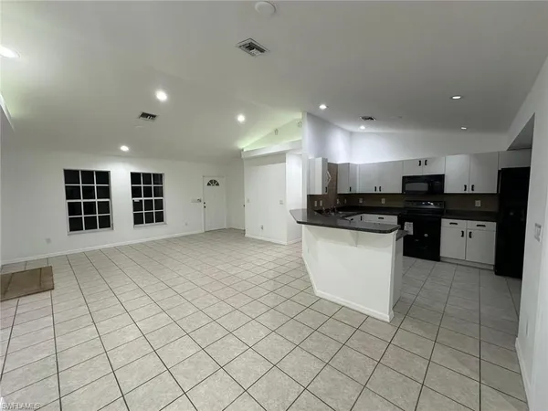 a view of kitchen with stainless steel appliances cabinets