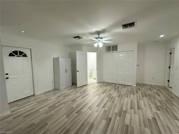 a view of an empty room and wooden floor