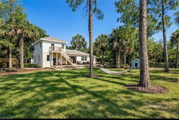 a view of a house with a yard porch and sitting area