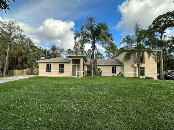 a front view of house with yard and green space
