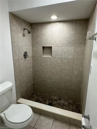 a bathroom with a toilet and shower