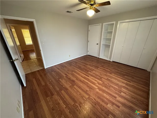 wooden floor in an empty room with a window