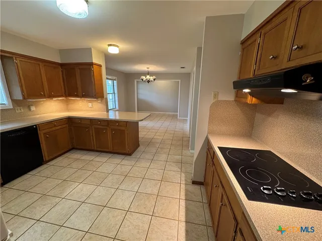 a kitchen with a sink a stove and cabinets
