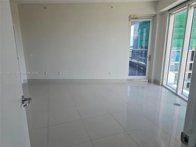 a white toilet sitting next to a white cabinet