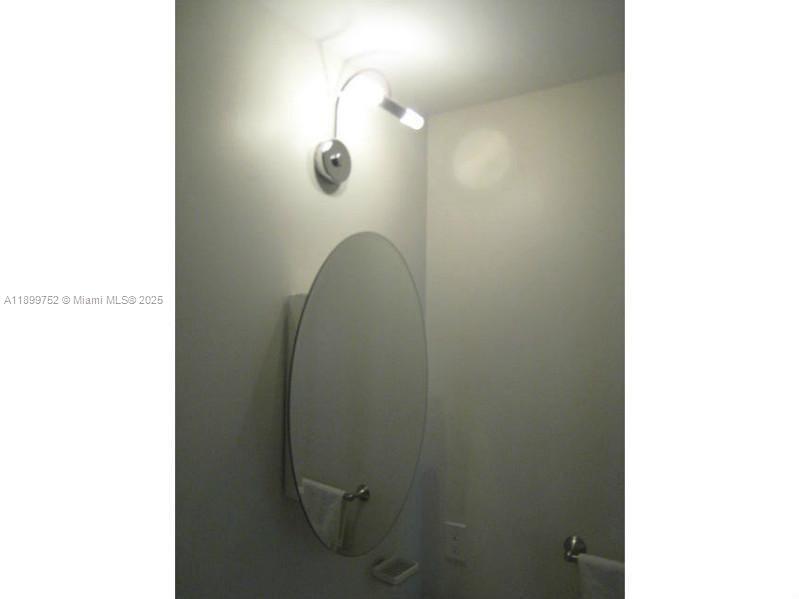 60 Southwest 13th Street, Unit 1900 Miami, FL 33130 - Photo 27 of 95 a bathroom with a mirror and a shower