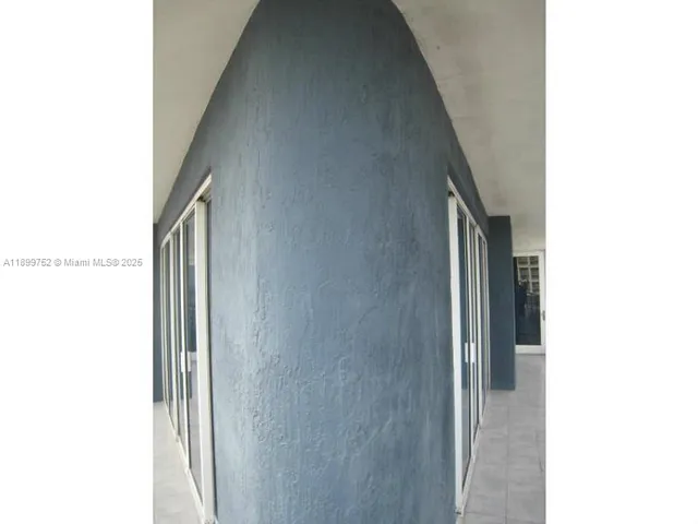 a bathroom with a glass shower door and a glass door