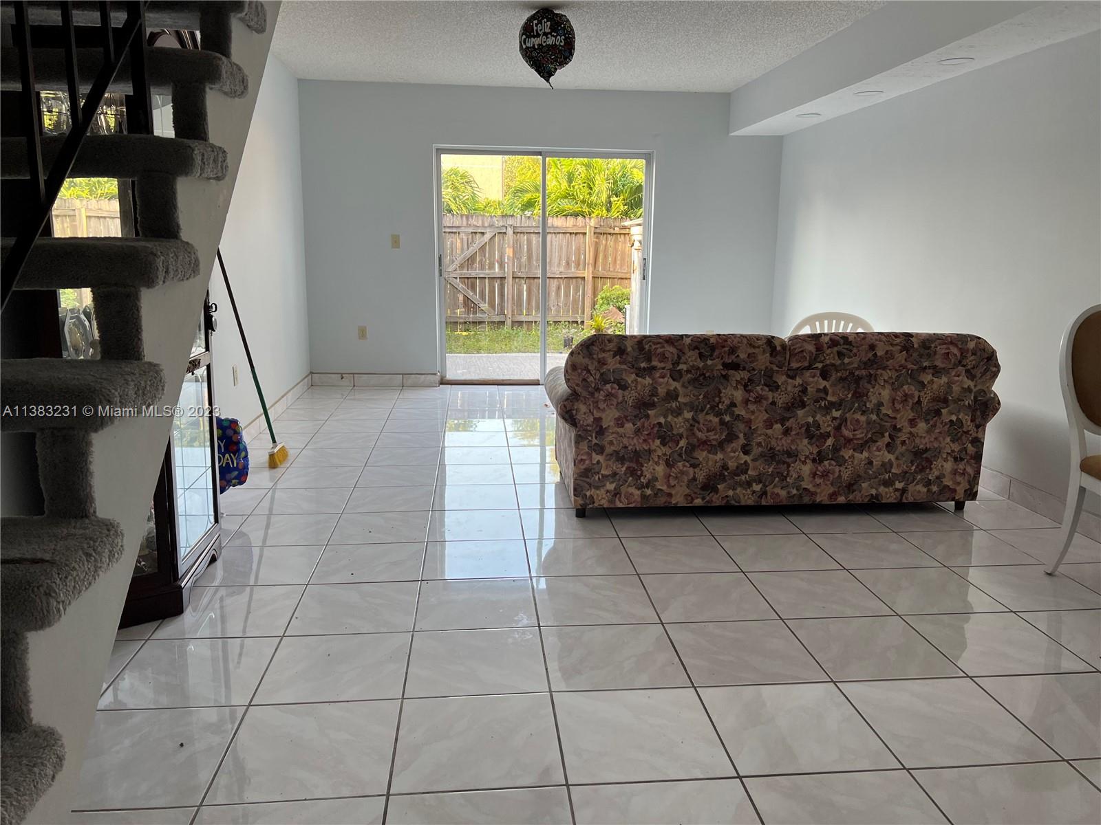 15103 Southwest 81st Street, Unit 213 Miami, FL 33193 - Photo 11 of 22 a living room with a couch and a flat screen tv