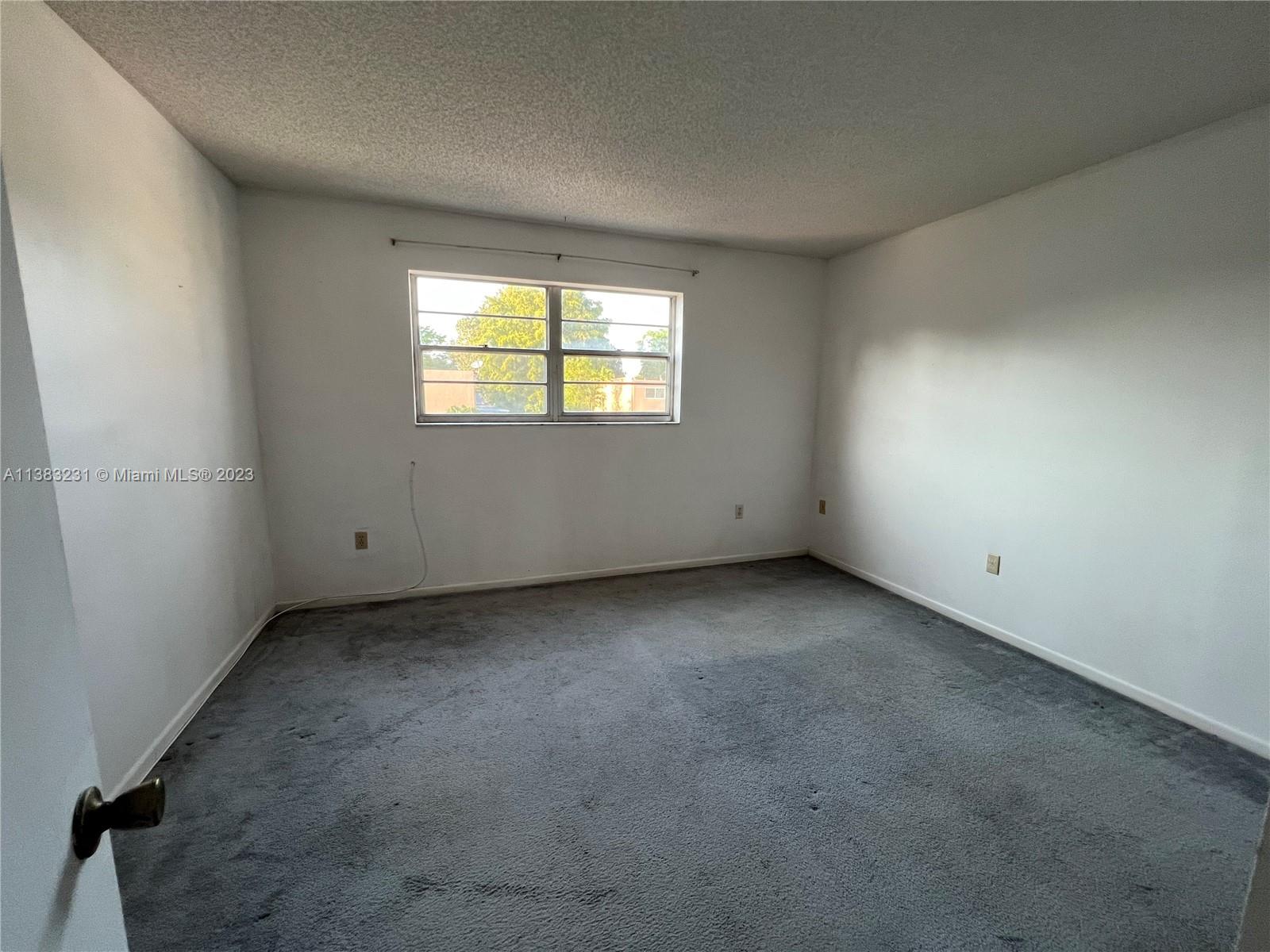 15103 Southwest 81st Street, Unit 213 Miami, FL 33193 - Photo 19 of 22 an empty room with a window