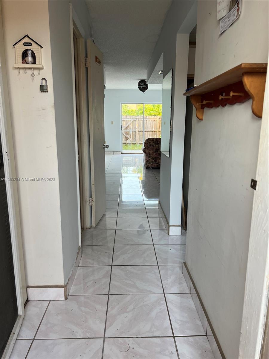 15103 Southwest 81st Street, Unit 213 Miami, FL 33193 - Photo 4 of 22 a hallway view with a sink
