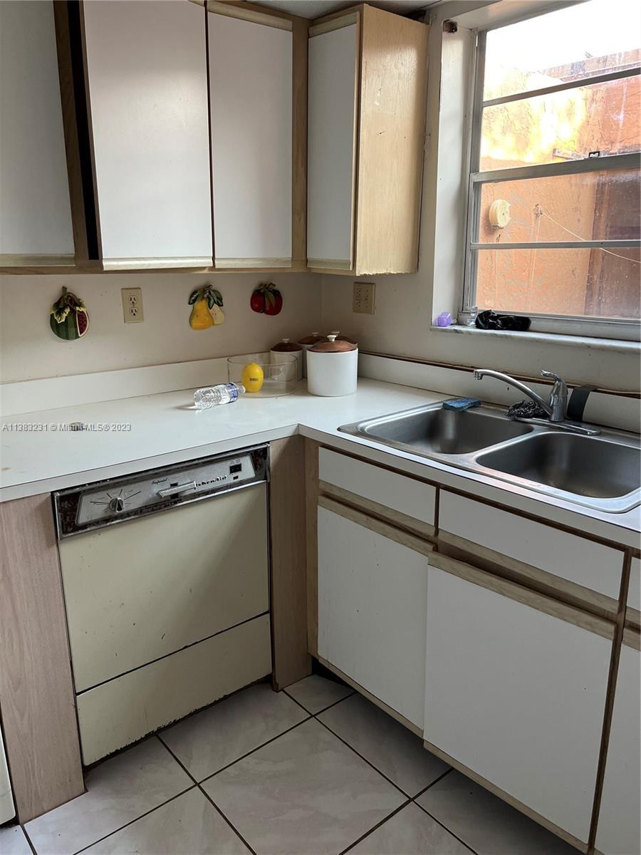 15103 Southwest 81st Street, Unit 213 Miami, FL 33193 - Photo 7 of 22 a kitchen with a sink and a window