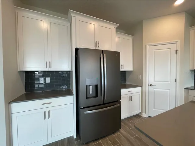 a kitchen with stainless steel appliances a refrigerator and cabinets