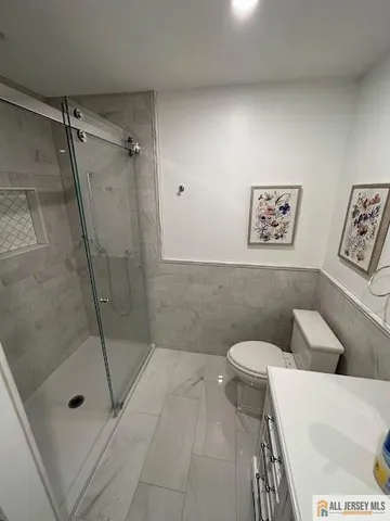 a spacious bathroom with a toilet sink and mirror