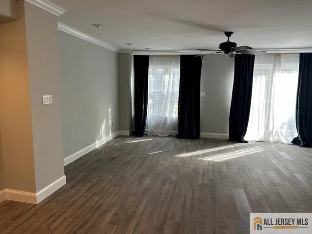 a view of a room with wooden floor and stairs