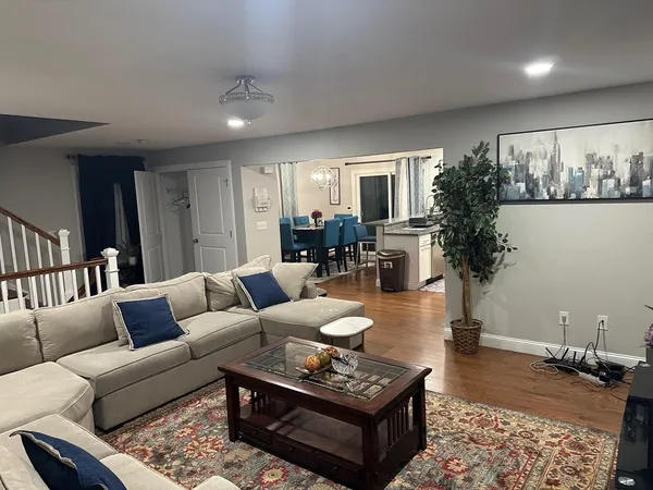 a living room with furniture and wooden floor